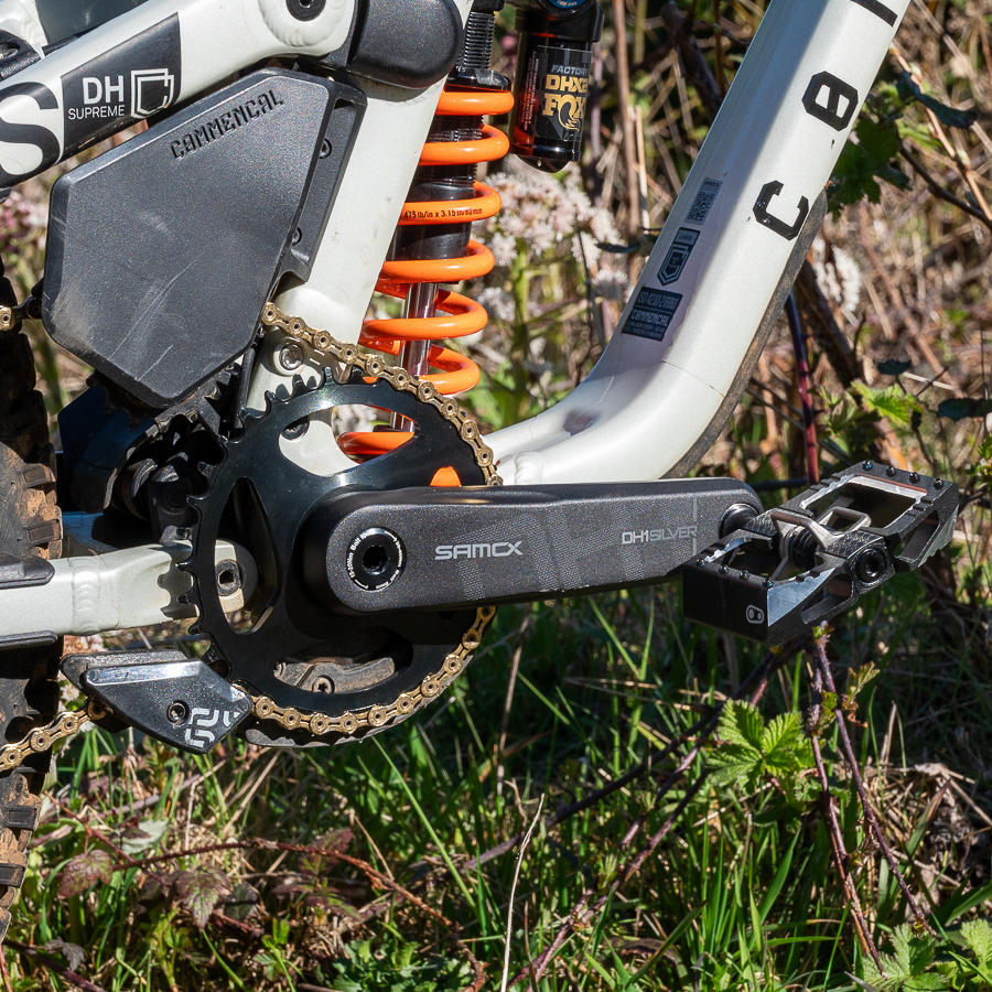 Close-up of a bicycle chain and gear system with a natural background